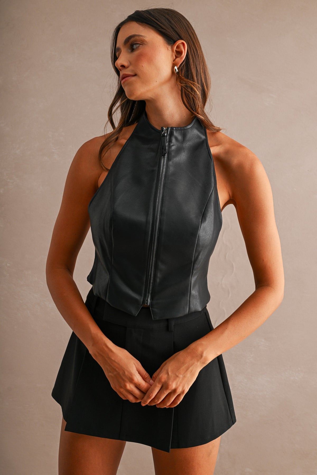Black faux leather halter corset top with exposed front zipper, front view