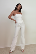 Model wearing white strapless corset jumpsuit